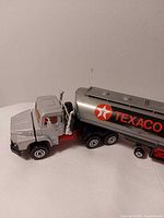 Left side view of Majorette Texaco tanker truck showing cab, trailer, wheels and logo