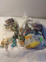 Group view of five bags with assorted beads and jewelry parts
