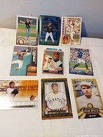 Overall layout of nine baseball cards on white surface