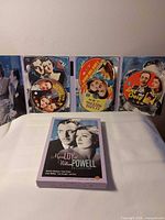 Slipcover and open tri-fold case showing three discs with film titles visible