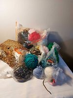 Group view of mixed yarn balls and skeins on table