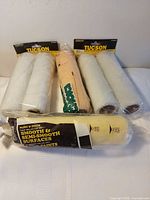 Five of the six sealed roller covers displayed upright and flat