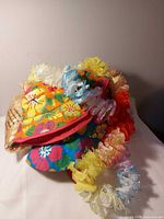 Group shot showing hat, leis and packaged hula skirts