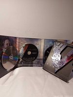 Slipcover, open case, three discs visible