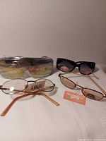 All four pairs displayed: wraparound shield, black plastic frame, two oval metal frames