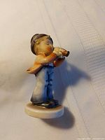 front view of ceramic boy figurine on base