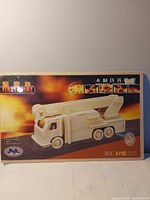 Front of sealed box with image of completed wooden fire truck model and model number G-P103
