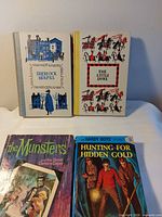 All four hardcover youth novels laid out