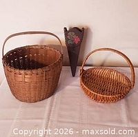 Large oak basket, smaller rattan basket, wooden wall pocket displayed together