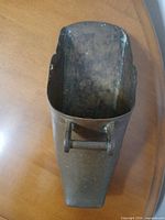 Top view inside brass stirrup showing hanger loop and patina