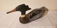 Left side view of wooden merganser decoy