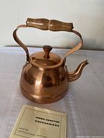 Copper kettle with lid and manual front view