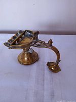 Side view showing five-wick tray, handle, pedestal base