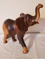 front left view of two-tone wooden elephant figurine