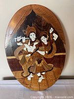 Front view of oval inlaid plaque showing Radha Krishna scene