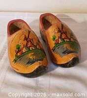 Pair of clogs angled front view showing painted windmill scenes