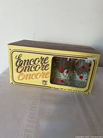 Exterior of Encore box with view window showing rose glasses