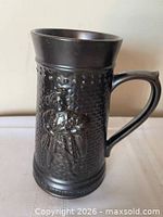 Front view of dark glazed ceramic stein with King Henry VIII relief
