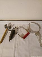 All four kitchen tools laid out on white cloth