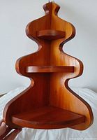 Front view showing three shelves and curving sides