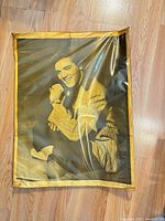 Full view of poster in plastic sleeve on floor