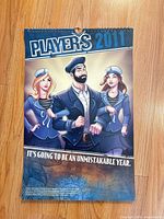 Front cover of the 2011 Player's calendar showing artwork and title
