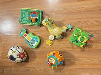 All six baby toys arranged on floor