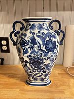 Front view of blue and white Bombay porcelain vase with floral pattern and handles