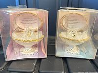 Both trinket boxes in original clear boxes showing front view