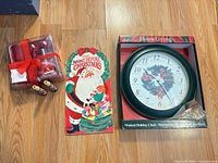 Overview of all items: clock in box, book, candle pack, two tin noisemakers