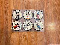 Full set of six coasters in sleeve, front view