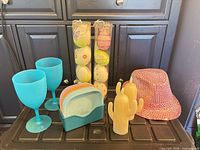 All items grouped: cactus candles, goblets, bowls in holder, egg tubes, sequin hat