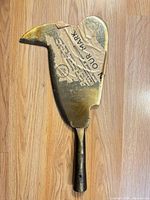 Full view of cutter head showing overall form and markings covered by paper