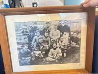 Full view of framed team photograph showing frame, mat and print
