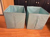 Front view of both IKEA light blue fabric bins