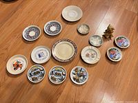 All twelve plates, dishes and figurine laid out on floor