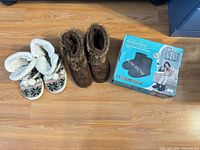 Overview of all three items on floor: knit slippers, brown boot slippers, boxed massaging booties