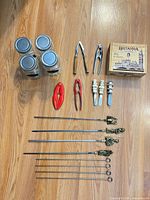 All items laid out: jars, crackers, spreaders, tea box, skewers