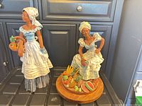 Both figurines side by side showing overall form and height comparison