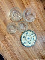 Overhead view of four glass bowls and ceramic platter