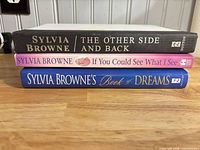 Spines of three Sylvia Browne books: The Other Side and Back, If You Could See What I See, Book of Dreams