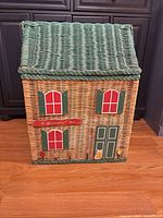Front view showing house motif, green roof, red shutters