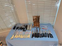 Full lot layout showing all knives, sharpeners and packaging on table