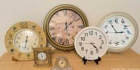 All six clocks displayed together for size and variety reference