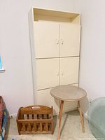 Cabinet, table, magazine rack visible