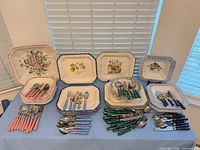 Full lot showing plates and four colour groups of flatware