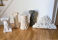 Group view of four pedestals and wall plaque