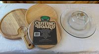 overview showing three wooden cutting boards and glass dome with plate