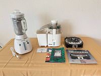 Overall view of blender, juicer, burner, manuals and cassette