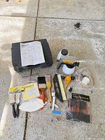All items laid out: power painter, case, brushes, spreaders, sanding sheets, accessories